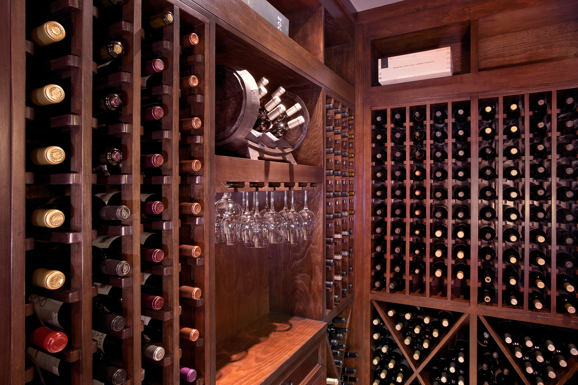 Side view of wine cellar centerpiece with elegant glassware display.  - Glenview Haus - Custom Doors, Wine Cellars and Cabinets in Chicago