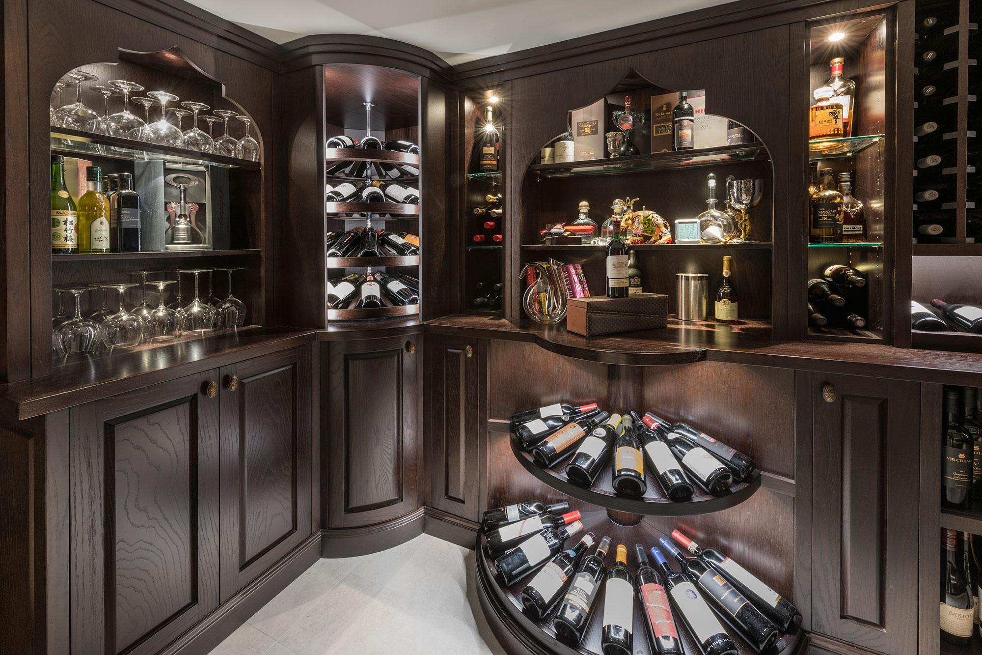 Tiered solid wood apron displays below solid wood shelving unit.  - Glenview Haus - Custom Doors, Wine Cellars and Cabinets in Chicago