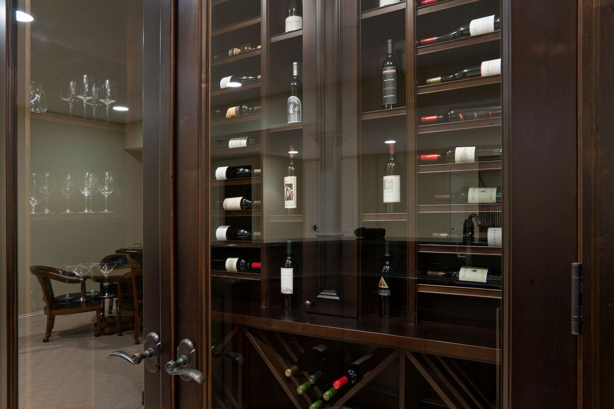 Custom made double glass door enhances presentation of various wines.  - Glenview Haus - Custom Doors, Wine Cellars and Cabinets in Chicago