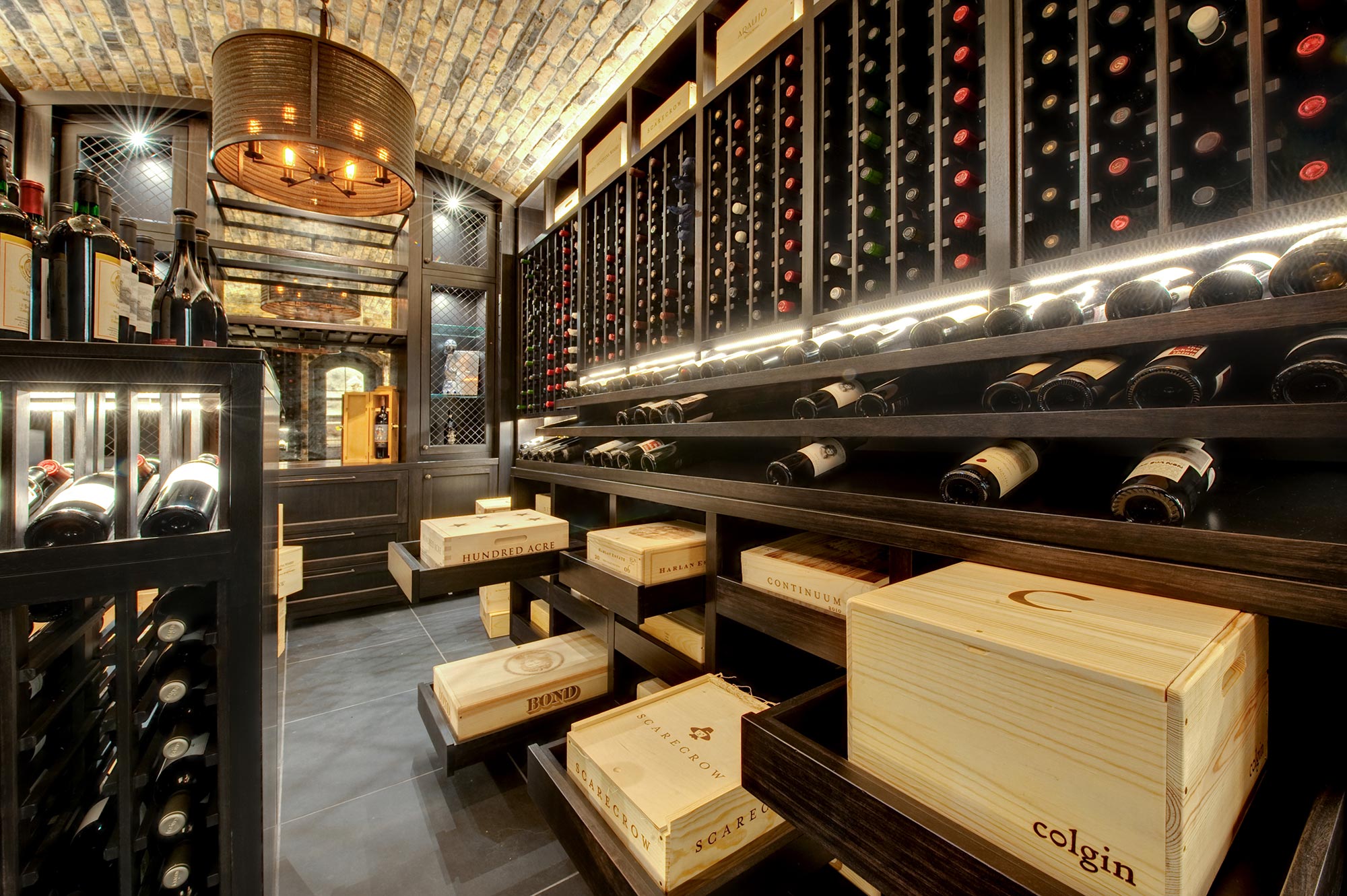 Movable, self closing wooden shelving providing effortless access to wine cases.  - Glenview Haus - Custom Doors, Wine Cellars and Cabinets in Chicago